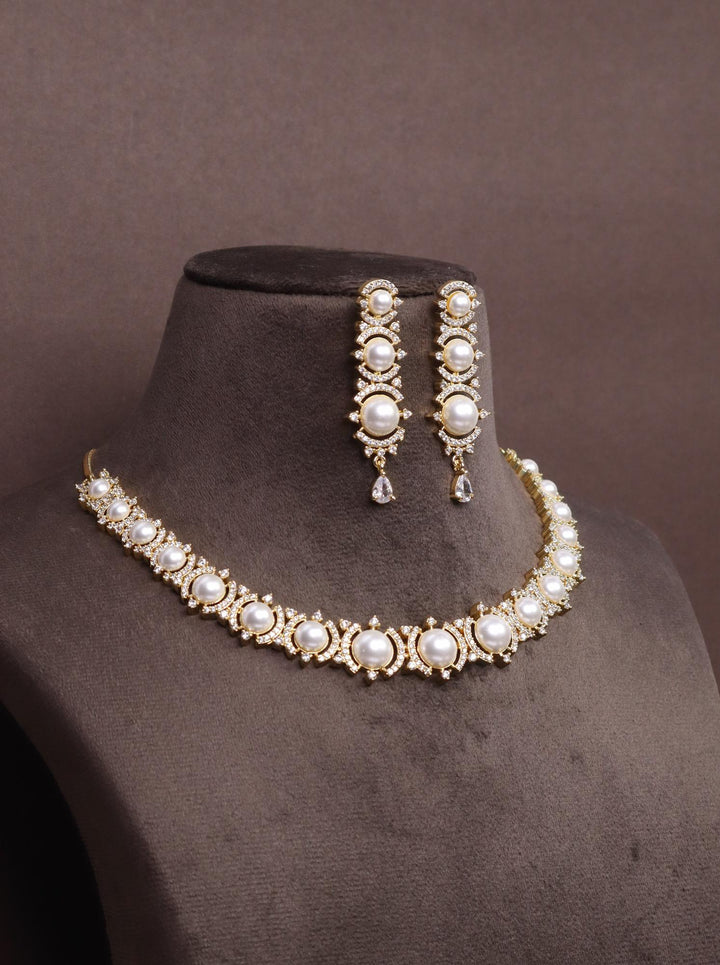 A closeup image of Mitali Pearl Necklace Set -4 by Live Some India on a brown dummy 