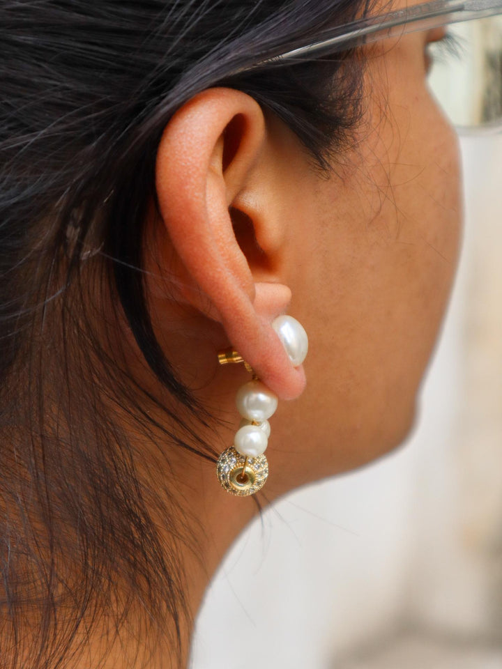 A closeup image of a girl wearing Multi Beaded White Pearl Earrings by Live Some India 