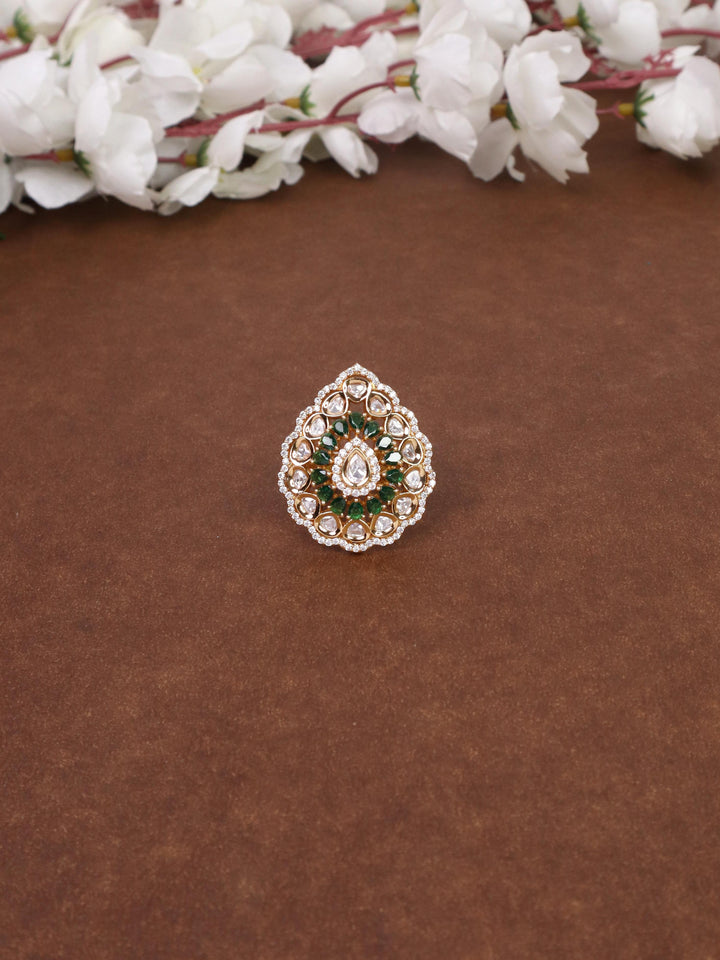 A closeup image of Naina Kundan Polki Green Ring -1 by Live Some India on a brown background