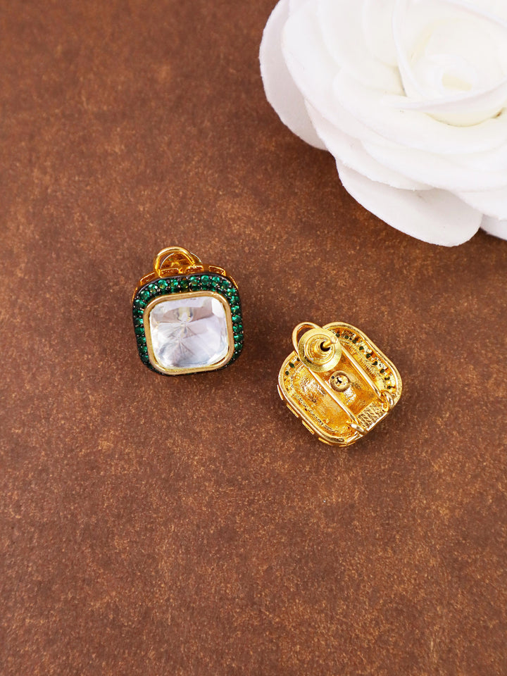 A closeup image of Nia Green Kundan Polki Stud Earrings 1 by Live Some India on a brown background with a white rose 