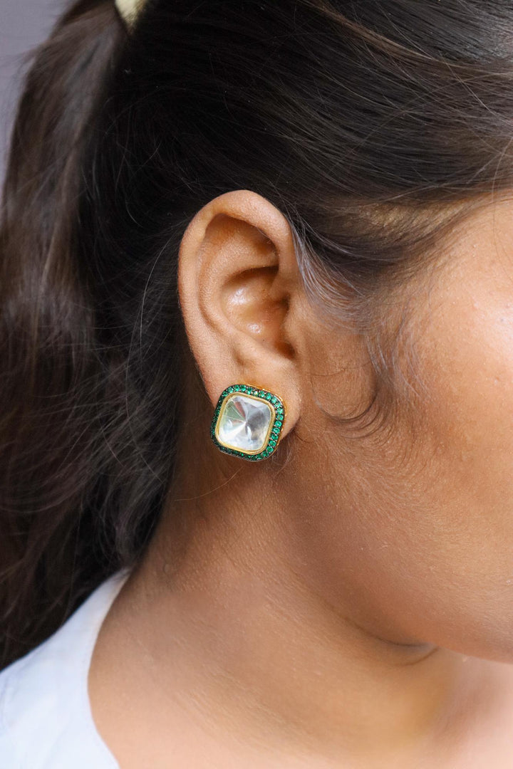 A closeup image of a girl wearing Nia Kundan Polki Green Stud Earrings -1 by Live Some India 