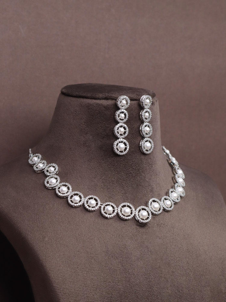 A closeup image of Nitya Pearl Necklace Set -5 by Live Some India on a brown dummy 