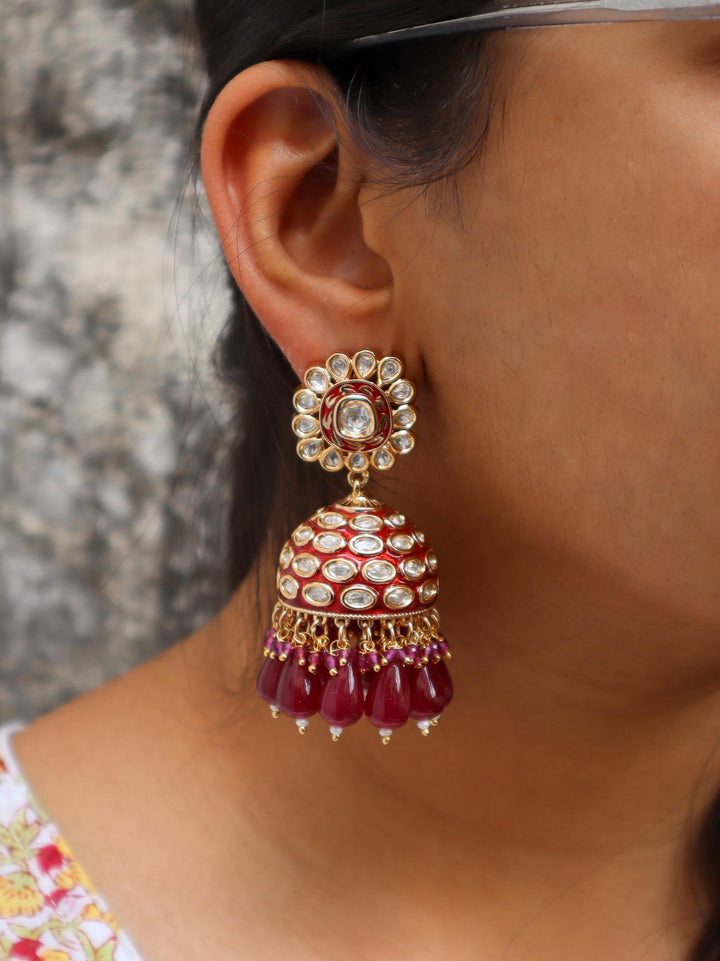 A closeup image of a girl wearing Niyara Kundan Polki Jhumka Earrings -2 by Live Some India 