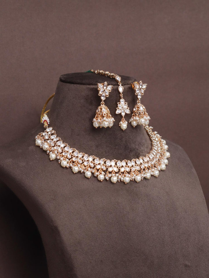 A closeup mage of Niyara Kundan Polki Necklace Set with Maang Tikka by Live Some India on a brown dummy 