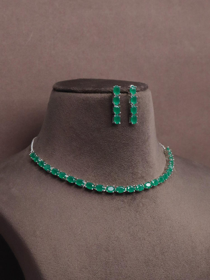 A closeup image of Oval Emerald Diamond Necklace Setby Live Some India on a brown dummy 