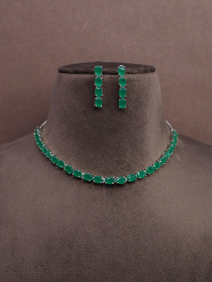 A closeup image of Oval Emerald Diamond Necklace Set -1 by Live Some India on a brown dummy 