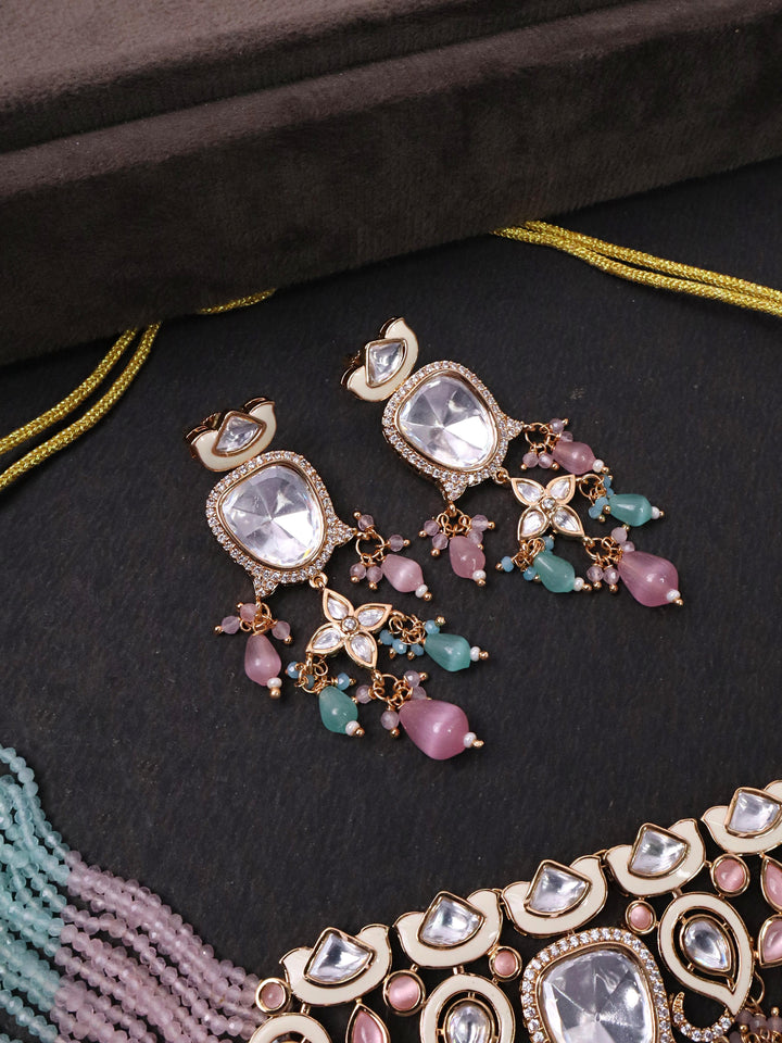Close up image of earrings of Pastel Kundan Meena Choker with White Meenakari by Live Some India on a black background 