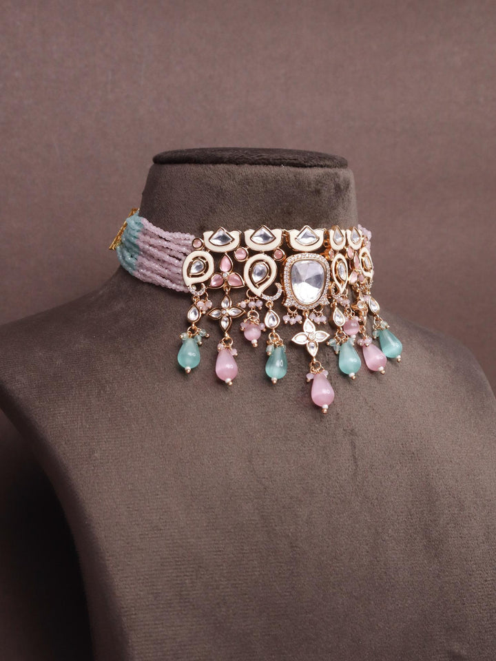 A closeup image of Pastel Kundan Meena Choker with White Meenakari -2 by Live Some India on a brown background 