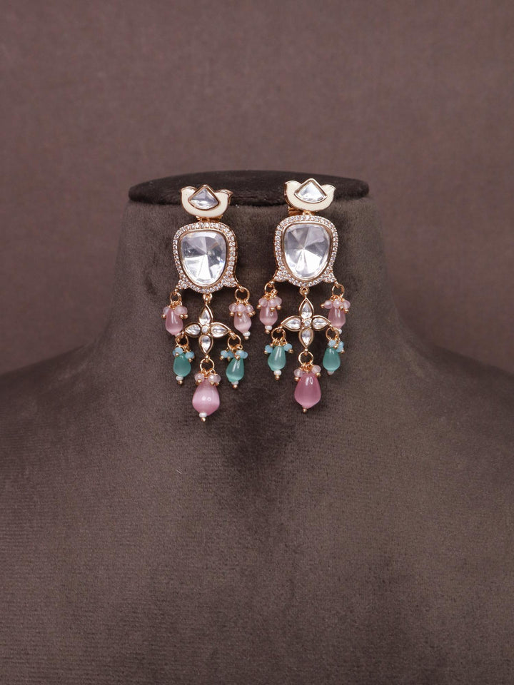 A closeup image of Pastel Kundan Meena Earrings with White Meenakari -2  by Live Some India ona  brown background 