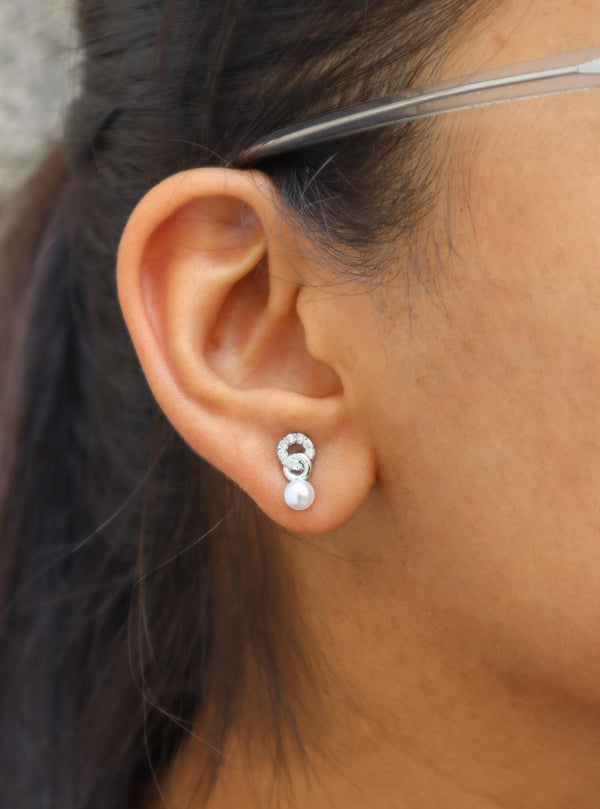 A closeup of a girl wearing Pearl Hooked Earrings by Live Some India 