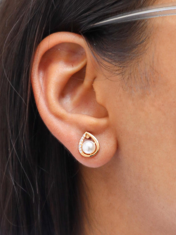 A closeup image of a girl wearing Pearl Leaf Earrings by Live Some India 