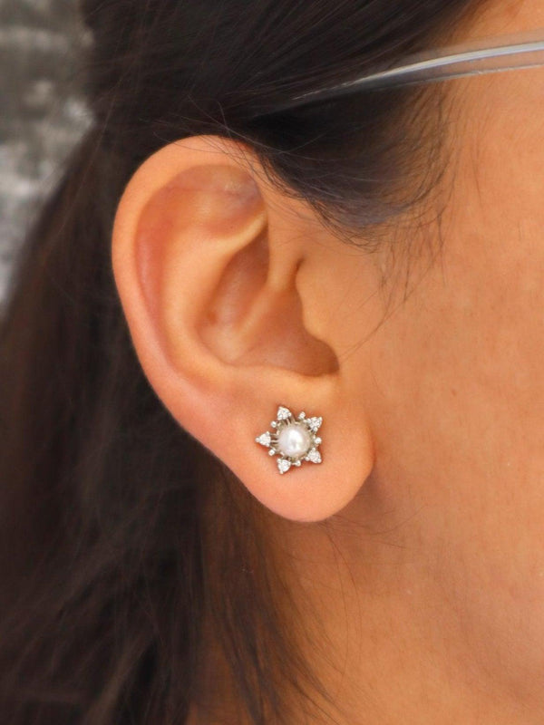 A closeup image of a girl wearing Pearl Studded Star Earrings by Live Some India 