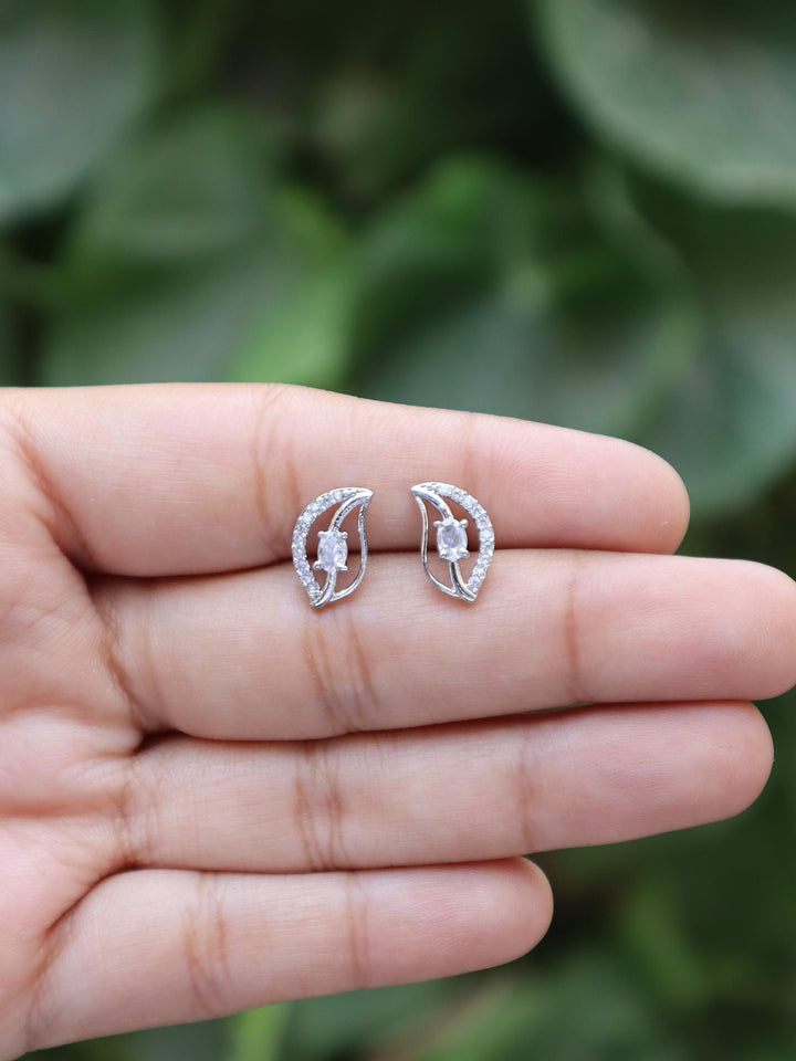 A closeup image of Petal Statement Earrings on a girl's hand by Live Some India 