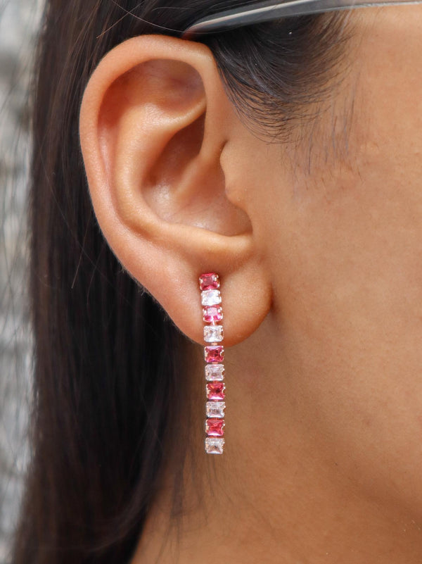 A closeup image of a girl wearing Pink Dimension Earrings by Live Some India 