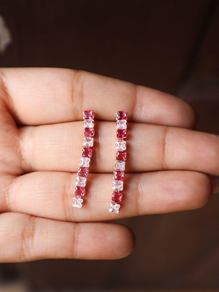 A closeup image of Pink Dimension Earrings -2 on a girl's hand by Live Some India