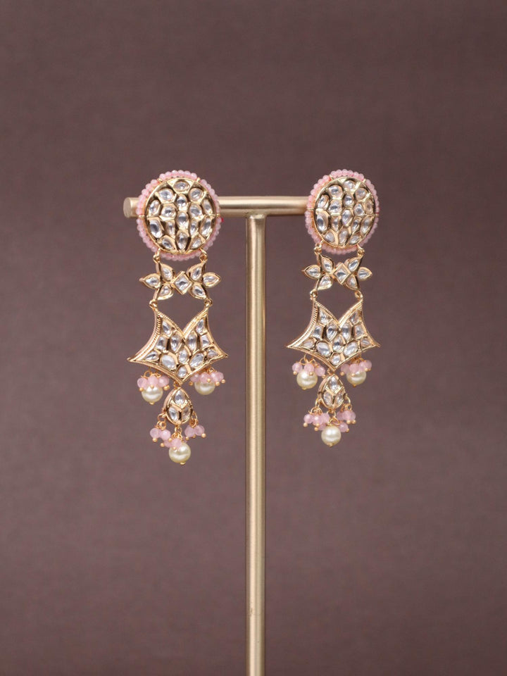 A closeup image of Pink Star Kundan Polki Dangler Earrings -2 by Live Some India on a brown background 