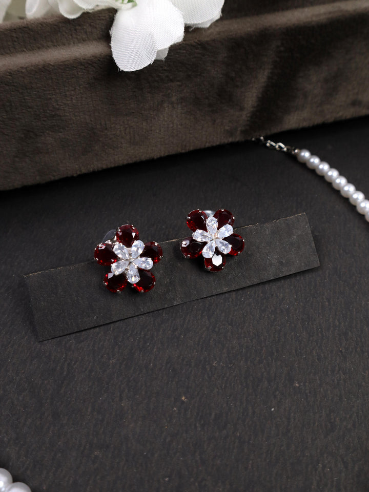 A closeup image of Red Flower Earrings by Live Some India on a black background 