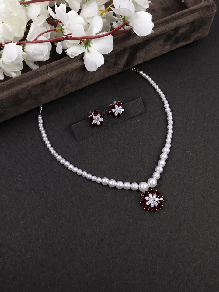 A closeup image of Red Flower Pendant Pearl Necklace Set by Live Some India on a black background 