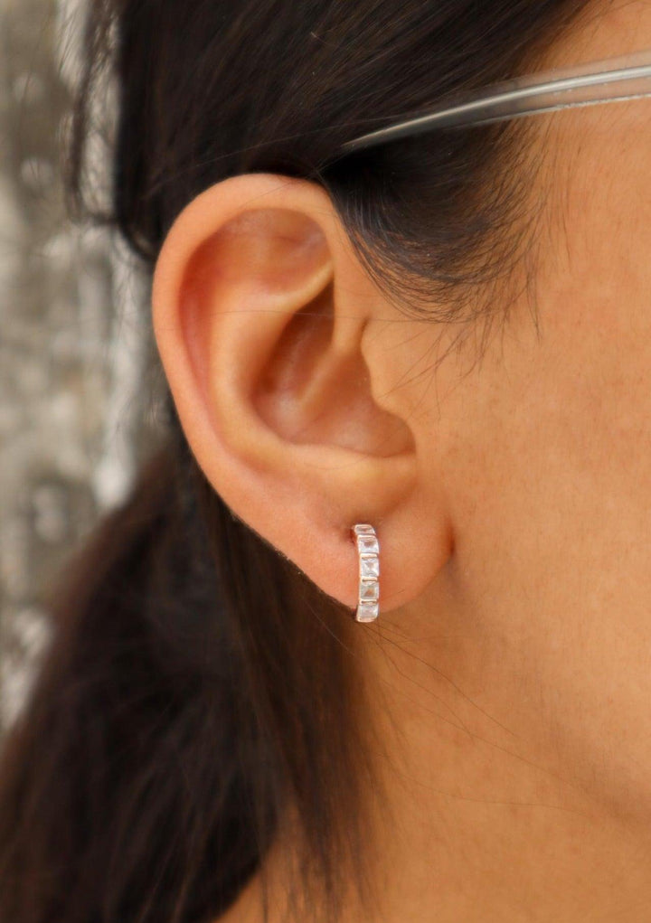 A closeup image of a girl wearing Rose Gold Huggies Earrings -2 by Live Some India 