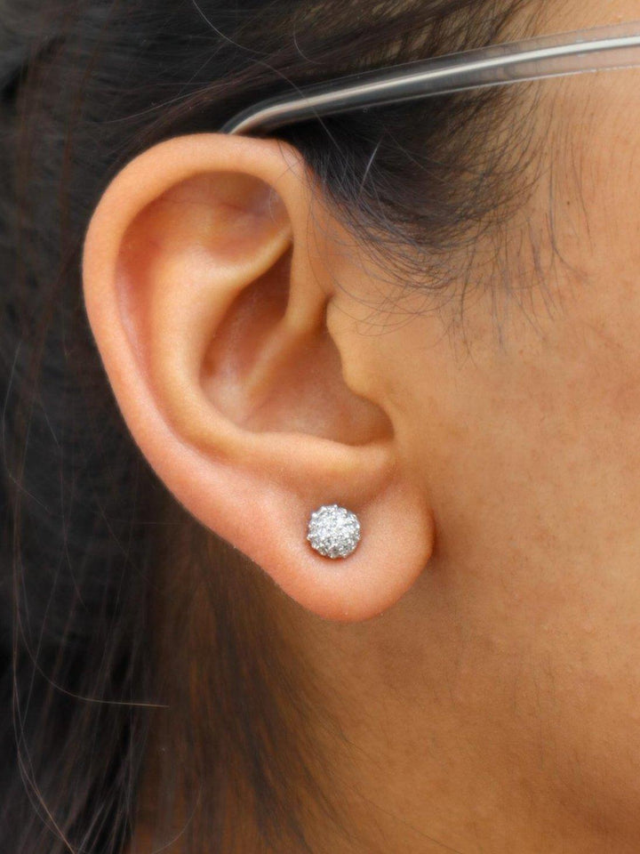 A closeup image of a girl wearing Round Dainty Earrings by Live Some India 