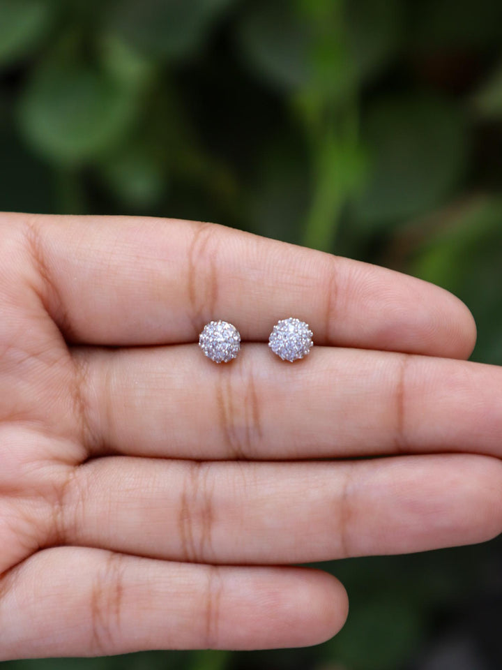 A closeup image of Round Dainty Earrings on a girl's hand by Live Some India 