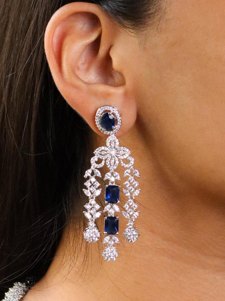 A closeup image of a girl wearing  Royal Sapphire Diamond Earrings  by Live Some India