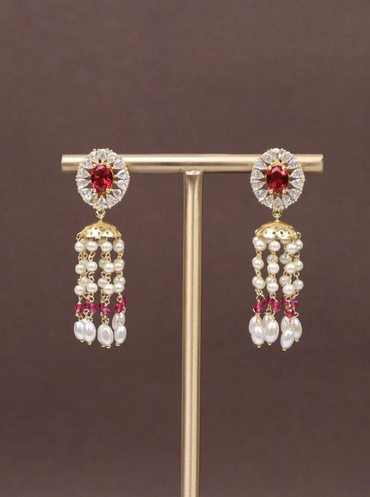 A closeup image of  Ruby Dome Contemporary Stud Earrings -1 by Live Some India on a brown background 