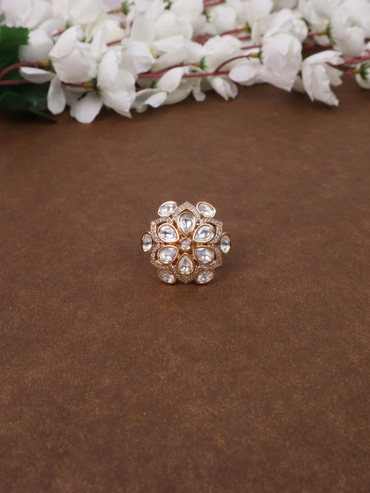 A closeup image of Sarah White Kundan Polki Ring by Live Some India on a brown background 