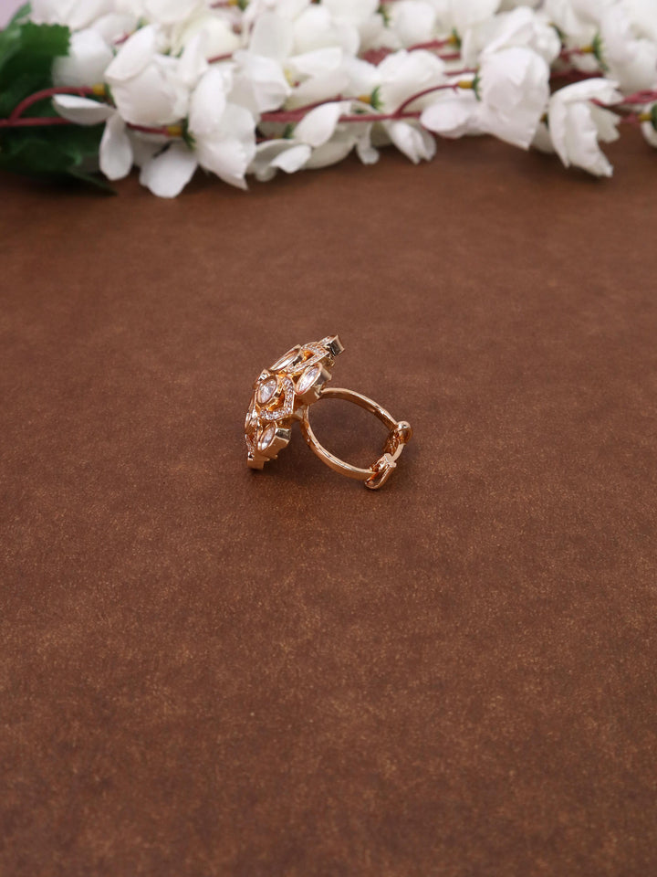 A closeup image of Sarah White Kundan Polki Ring -1 by Live Some India on a brown background