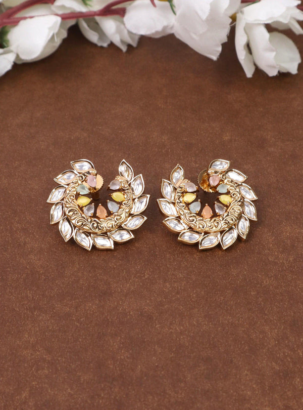 A closeup image of Shahi Multi Kundan Polki Stud Earrings by Live Some India on a brown background