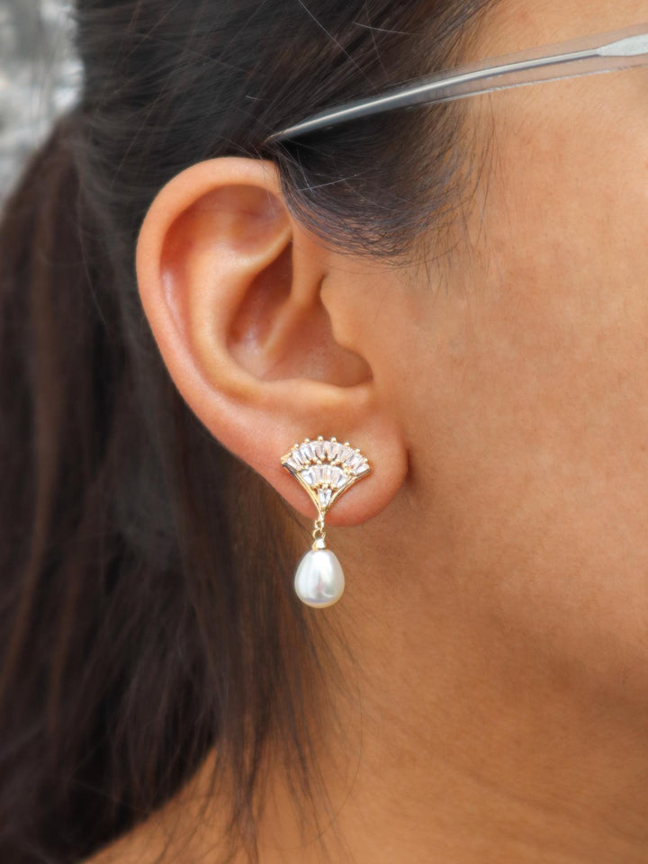 A closeup image of a girl wearing Shell with Pearl Earrings by Live Some India 