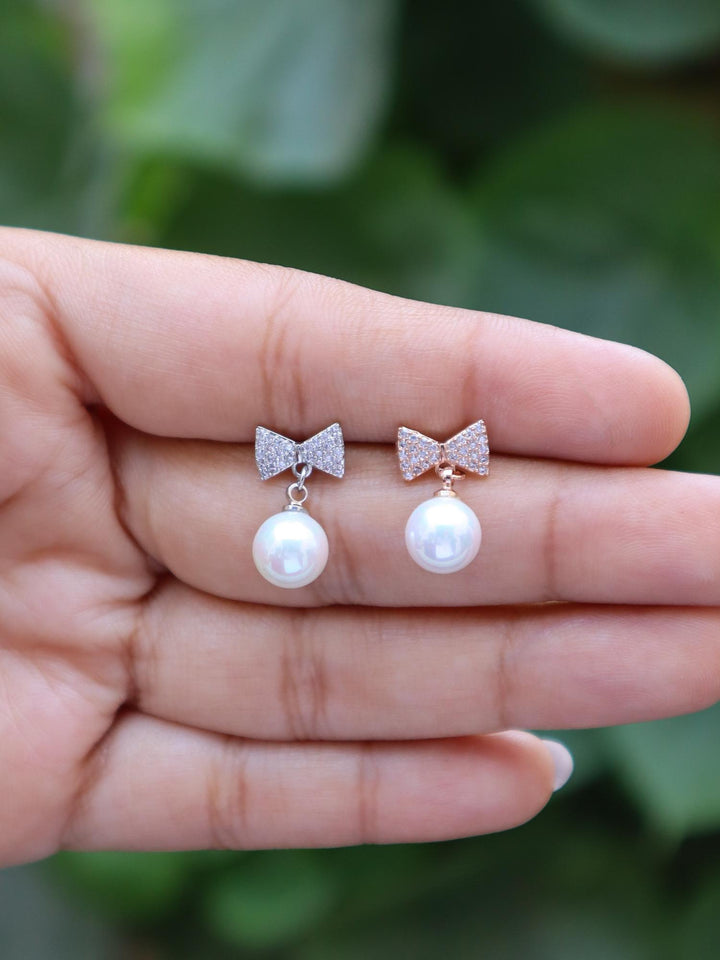 A closeup image of Shimmer Bow with a Pearl Earrings -1 by Live Some India 