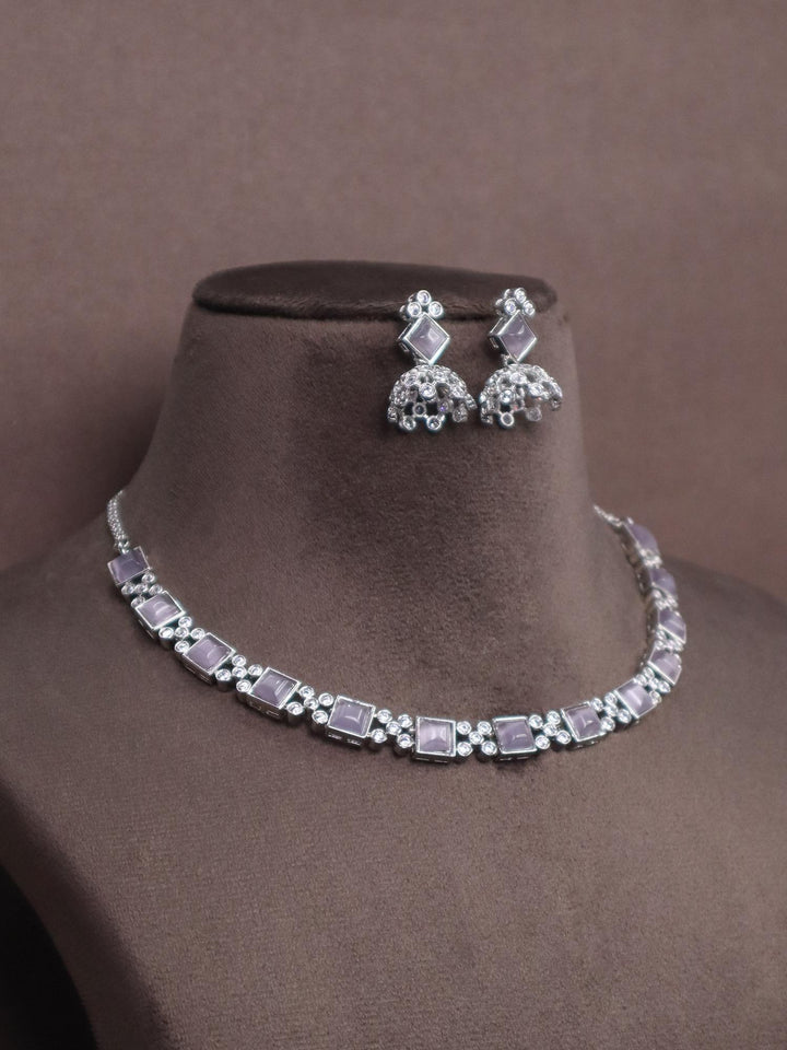 A closeup image of Silver Purple Diamond Necklace set by Live Some India on a brown dummy 