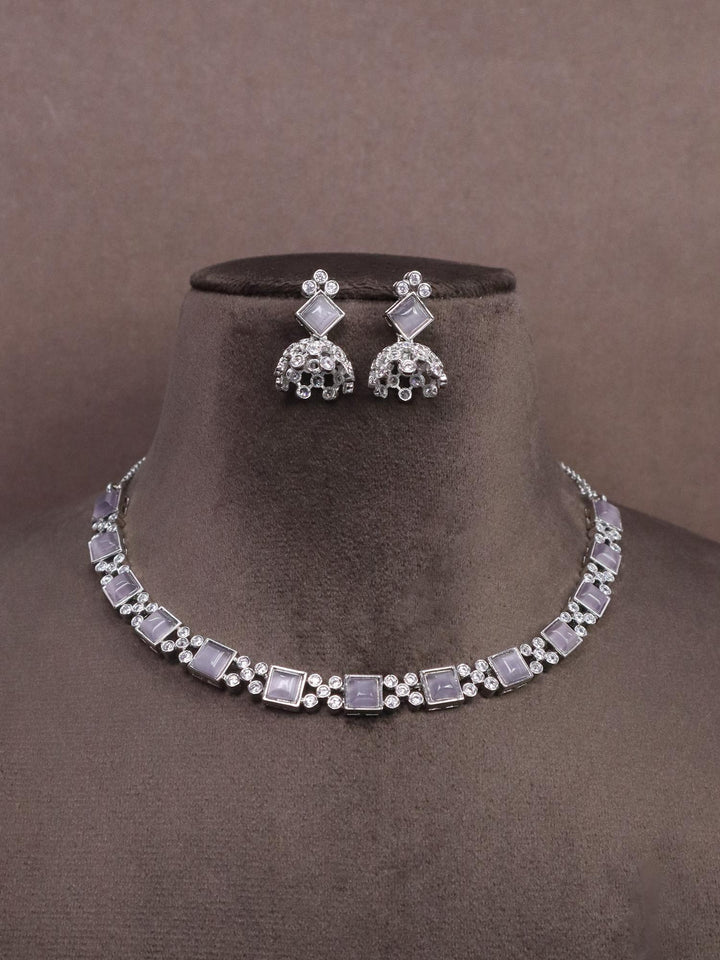 A closeup image of Silver Purple Diamond Necklace set -1 by Live Some India on a brown dummy 