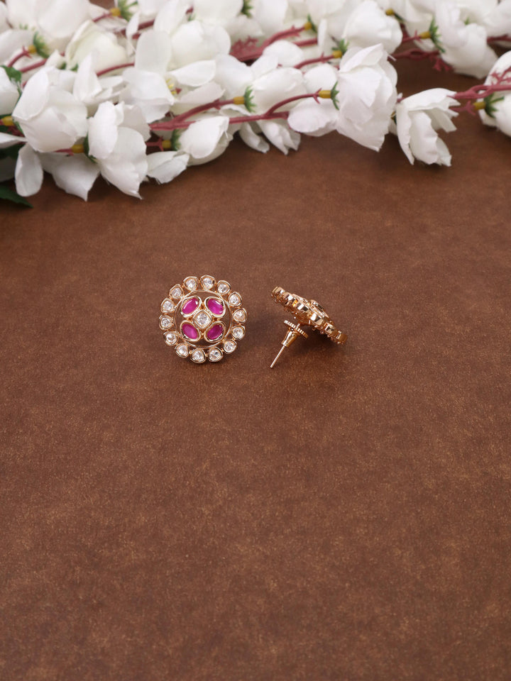 A closeup image of Siya Pink Kundan Polki Stud Earrings-1 by Live Some India on a brown background 