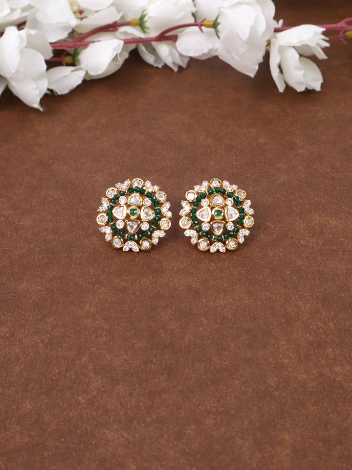 A closeup image of Soni Green Kundan Polki Stud Earrings by Live Some India on a brown background 