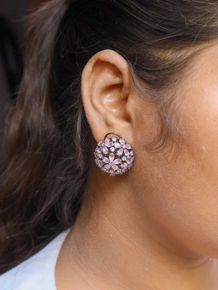 A closeup image of a girl wearing Starry Contemporary Stud Earrings by Live Some India 