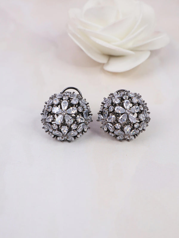 A closeup image of Starry White Contemporary Stud Earrings by Live Some India on a white background with a white rose