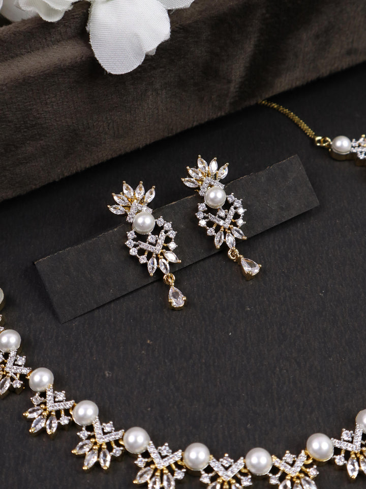 A closeup image of Sunrise Pearl Earrings  by Live Some India on a black background