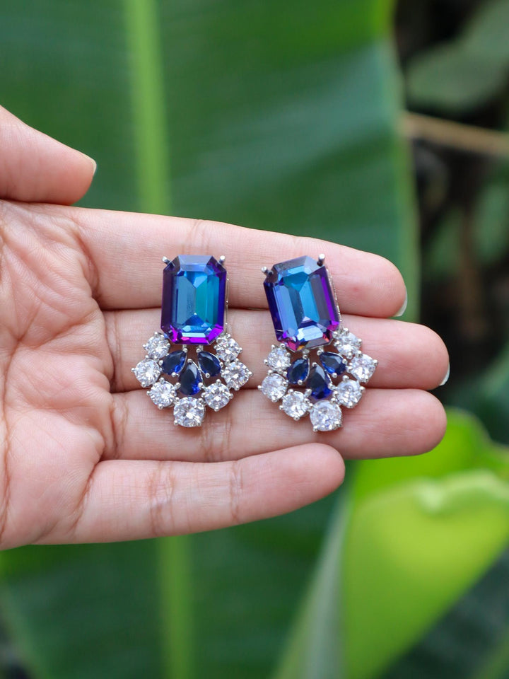 Swarovski_Inspired_Designer_Earrings by Live Some India on hands with green leaves background