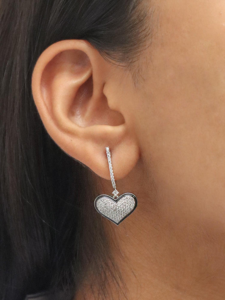 A closeup image of a girl wearing Swinging Hearts Diamond Earrings -1 by Live Some india 