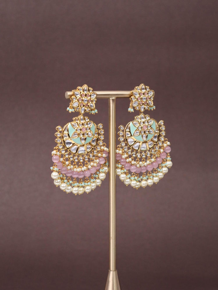 A closeup image of Trendy Green Kundan Polki Chandbali Earrings by Live Some India on a brown background