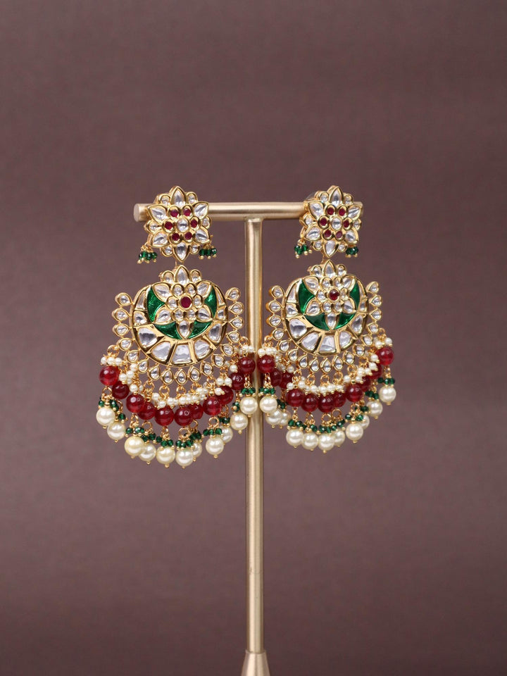 A closeup image of Trendy Red Kundan Polki Chandbali Earrings -1 by Live Some India on a brown background 