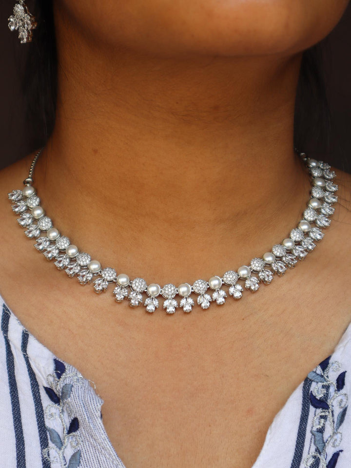 A closeup image of a girl wearing Tulip Pearl Necklace Set by Live Some India 