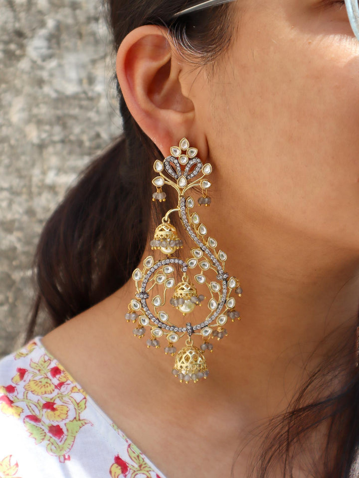 A closeup image of a girl wearing Unicorn Grey Kundan Poki Dangler Earrings by Live Some India 