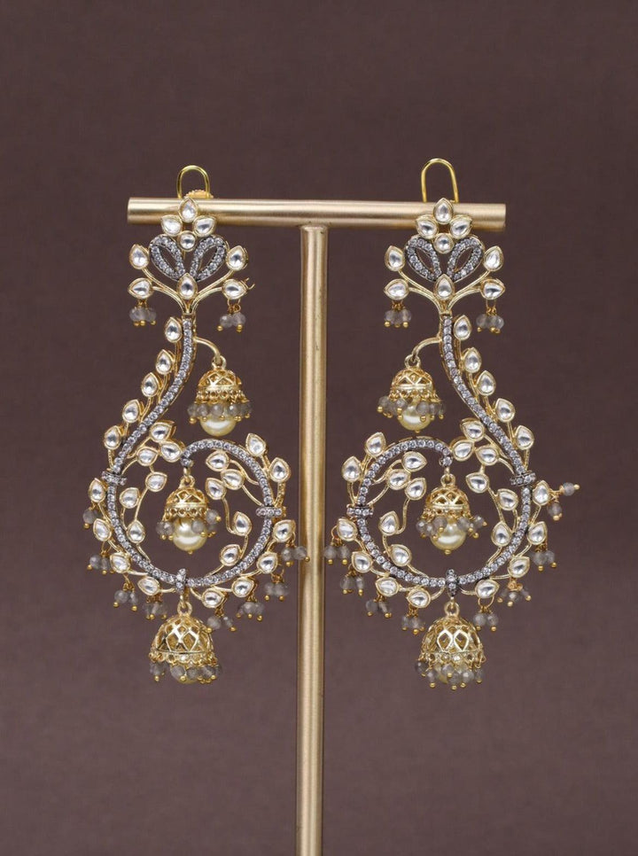 A closeup image of Unicorn Grey Kundan Poki Dangler Earrings -1 by Live Some India on a brown background 
