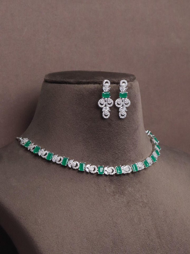 a closeup image of Unique Emerald Diamond Necklace set by Live Some India on a brown dummy 