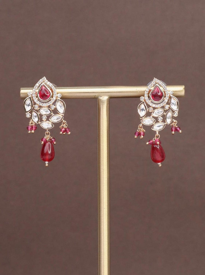 A closeup image of Urja Pink Pearl Kundan Polki Earrings by Live Some India on a brown background 