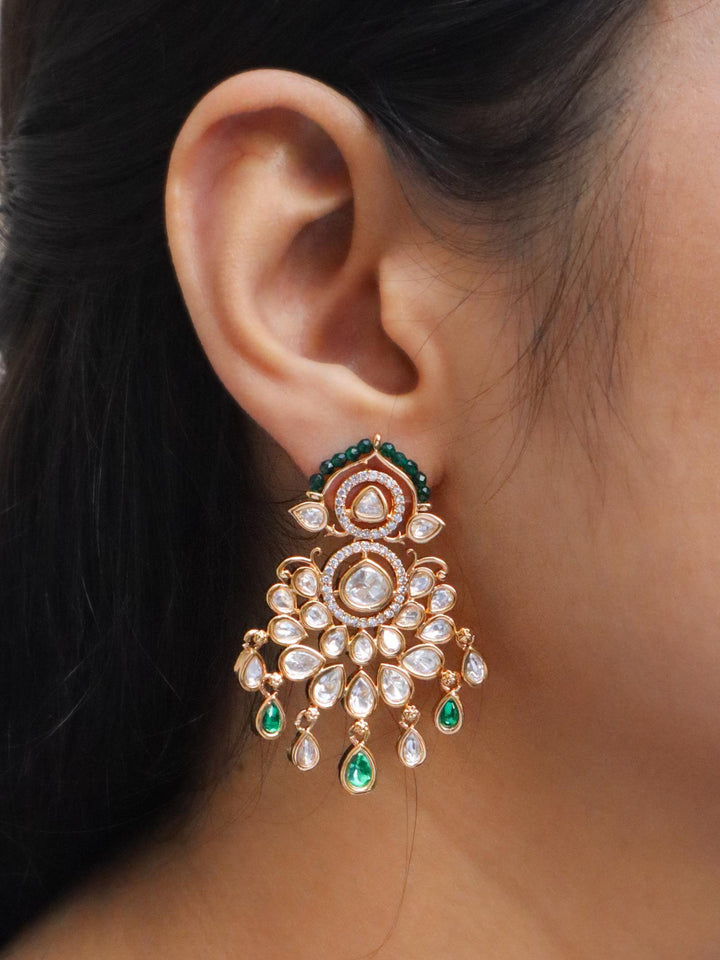 Ear of a girl wearing Yuri Kundan Polki Dangle Earrings in Green colour by Live Some India