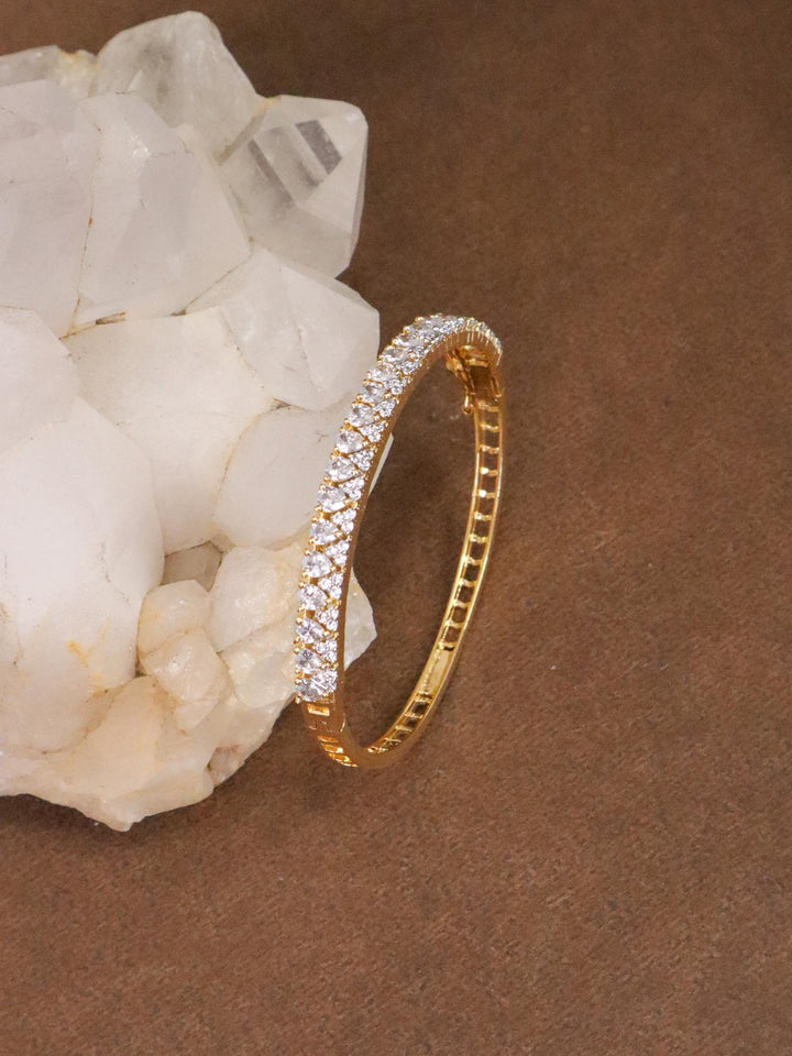 Anaya Designer Diamond Bracelet - by Live Some India in just Anaya Deigner Diamond Bracelet - Gold by Live Some India on a crystal with brown background